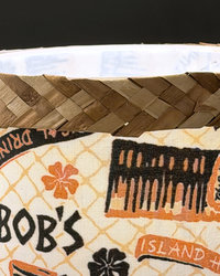 Tiki Bob tiki table lamp, lit, with vintage-inspired print shade