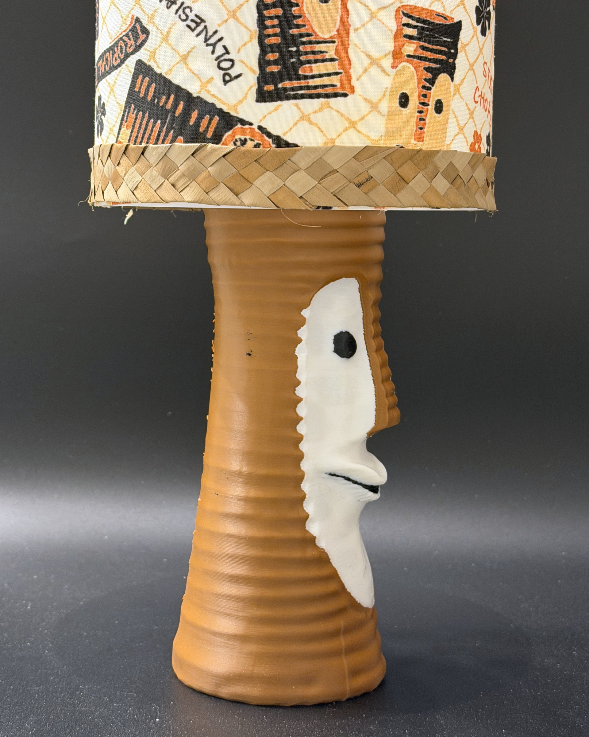 Tiki Bob tiki table lamp, lit, with vintage-inspired print shade