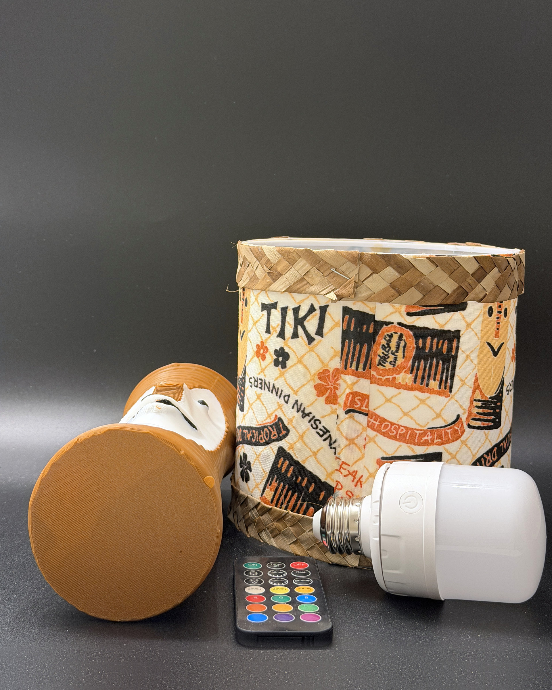 Tiki Bob tiki table lamp, lit, with vintage-inspired print shade